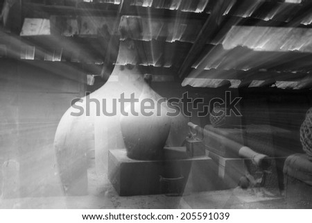 Black and white glass, wooden and metallic objects in the attic with dust and spiderwebs in a beautiful, moody light. Zoom effect