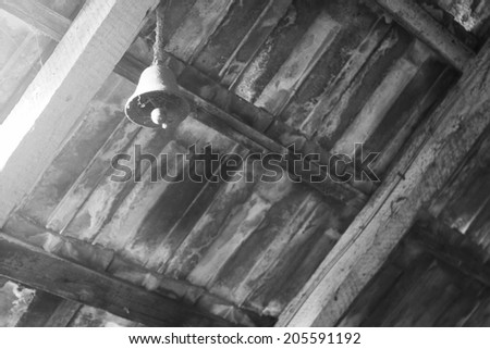 Black and white attic roof with metallic bell and light
