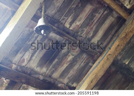Attic roof with metallic bell and light