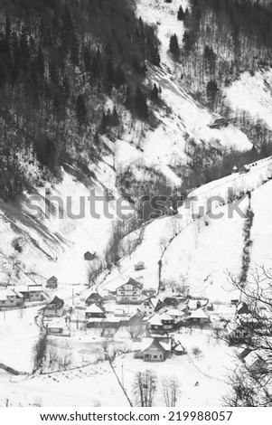 Winter mountain landscape with villages. Black and white photography