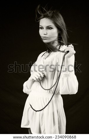 Black and white photo of beautiful caucasian girl posing with dark background