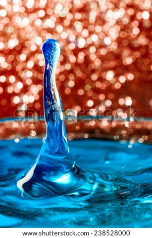 Abstract, colorful composition with small bokeh lights, water drops and water texture. Can be used as Christmas background