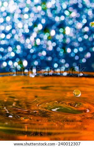 Abstract, colorful composition with small bokeh lights, water drops and water texture