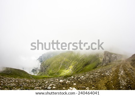 Landscape from Bucegi Mountains, part of Southern Carpathians in Romania in a very foggy day