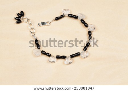 Silver jewels with colorful precious stones and wooden background