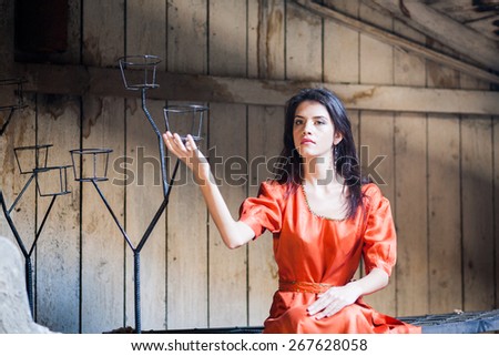 Beautiful, caucasian girl in a dress, posing in the attic. Artistic photography