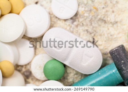 Composition with colorful pills and broken capsules