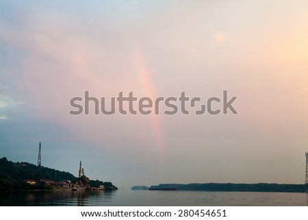 Sunrise and rainbow on the Danube at Oriahovo, the border between Romania and Bulgaria. View from the ferry