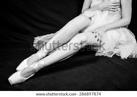 Woman legs and body wearing a dress with ballerina shoes. Monochrome photography