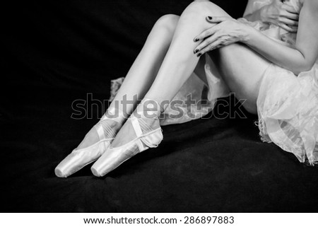 Woman legs and body wearing a dress with ballerina shoes. Monochrome photography