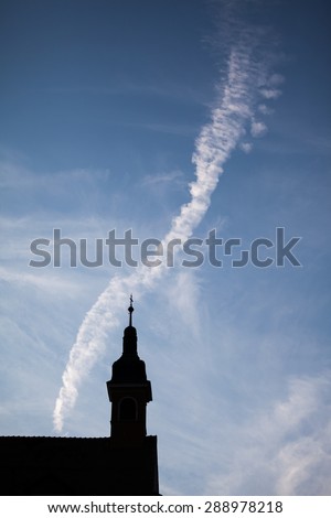 Silhouettes of towers and architectural parts with blue sky and white clouds in Sibiu, Romania