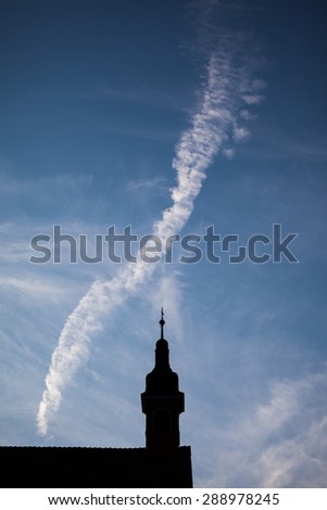 Silhouettes of towers and architectural parts with blue sky and white clouds in Sibiu, Romania