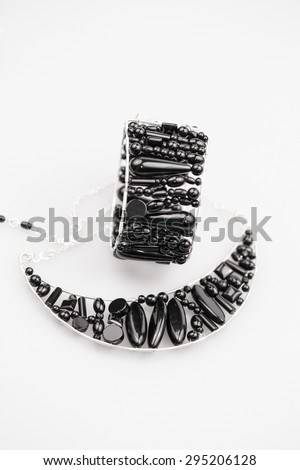 Silver jewels with onyx stones and light grey background