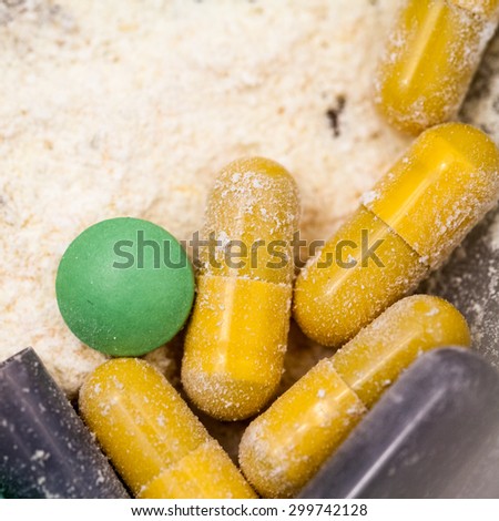 Composition with colorful pills and broken capsules