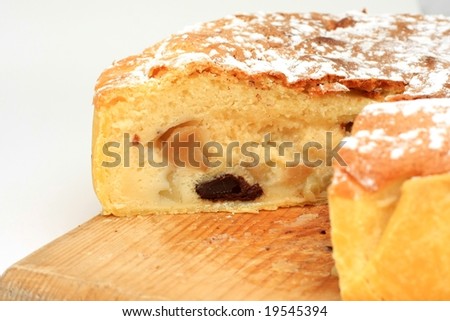 Sliced pie on a traditional wooden plate,