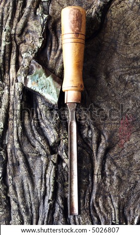 Old carving tool on a rocky surface