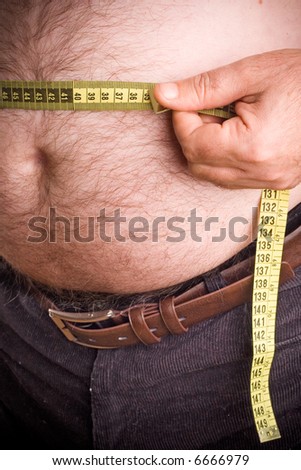Fat man holding a measurement tape