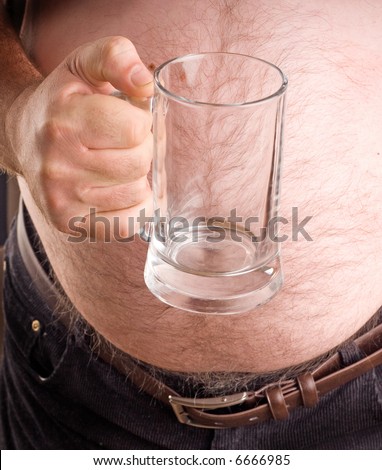 stock photo Fat man holding a beer glass