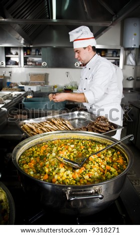Chef is preparing meals at restaurant kitchen