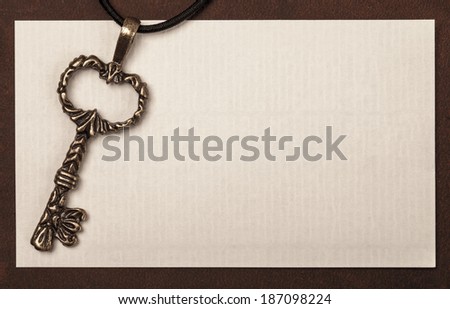 Vintage key and paper texture background with space for your text or image