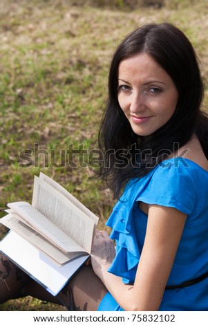girl reading book in spring park
