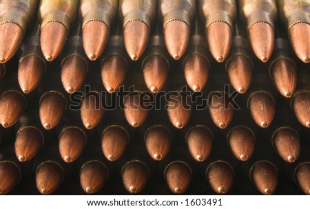5.56mm rifle cartridges in stripper clips stacked up, with points toward the viewer. Closeup.