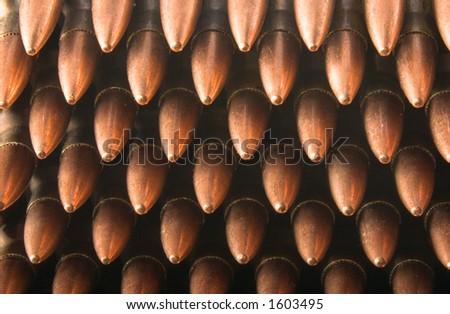 5.56mm rifle cartridges in stripper clips stacked up, with points toward the viewer. Closeup.