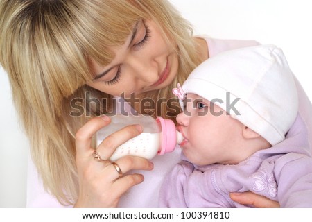 cute mom feeding baby on a white