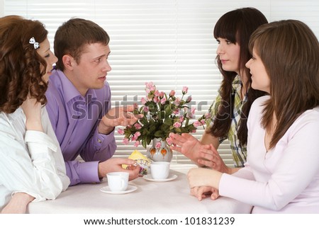 Luck Caucasian charming company of four men sitting at a table in a cafe