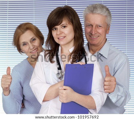 Beautiful young nice Nurse with elderly patient on a light background