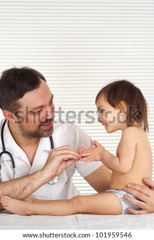 A beautiful nice doctor treats a child on a light background