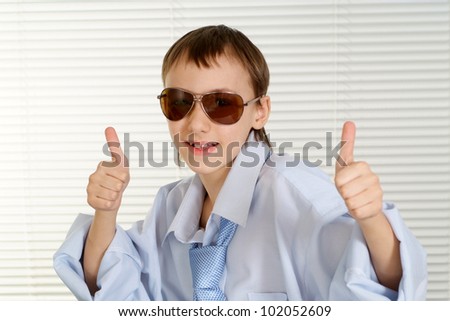Caucasian handsome young boy shows cool on a white background