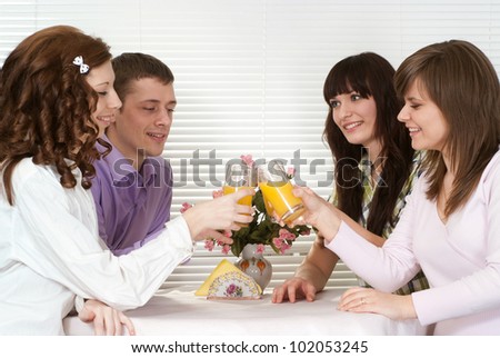 Beautiful charming company of four men sitting at a table in a cafe