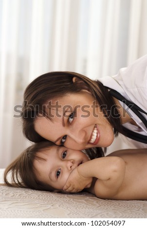 Beautiful nice Caucasian nurse treats a young girl on a light background