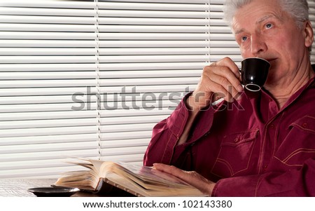 Caucasian adult man with a nice cup on a light background