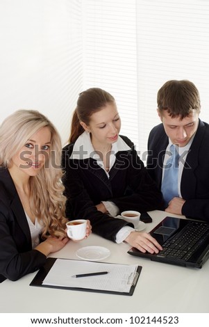 Caucasian pretty business company of three men working at a table on a white background