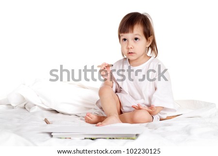 Pretty Caucasian young girl with a pencils in bed
