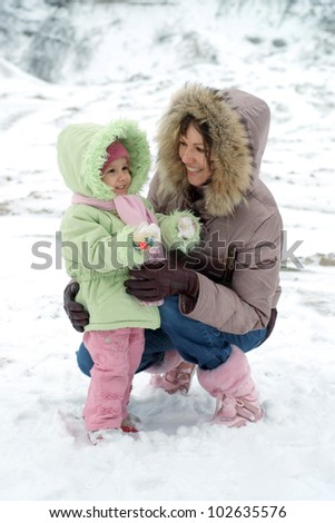 Mom and her pretty daughter in the winter