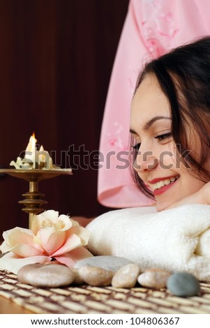 Luck Caucasian lady lying on a massage in the spa salon