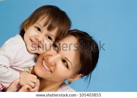 Luck Caucasian lady with a daughter on a blue background