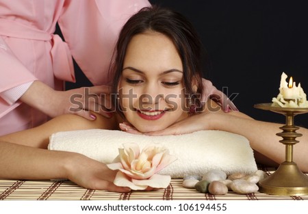 Beautiful Caucasian lady lying on a massage in the spa salon