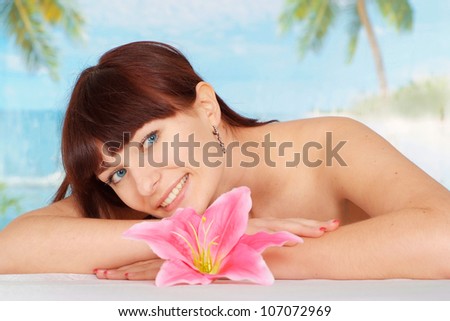 Pretty brunette is resting at a resort near the sea