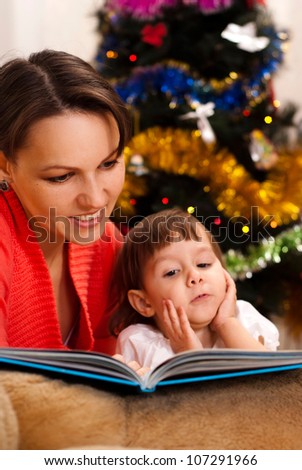 Caring mother decided to read to her child an interesting book on Christmas Eve