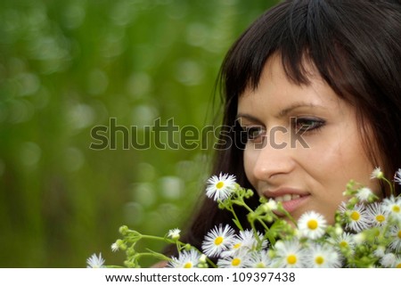 Good-looking brunette with a sweet expression on her face in the countryside