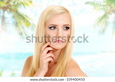 Beauteous blonde with a bright appearance is resting at a resort