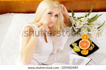 Attractive blonde with a bright appearance in her home
