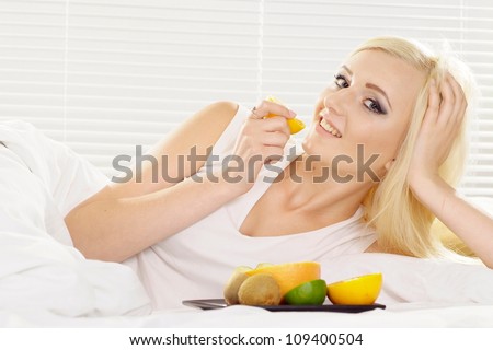 Attractive blonde with a bright appearance in her home