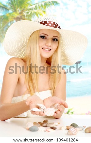 Good-looking blonde with a bright appearance is resting at a resort