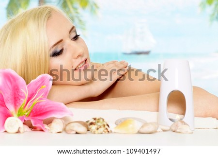 Attractive blonde with a bright appearance is resting at a resort