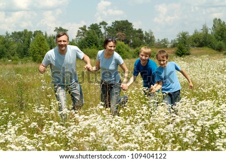 Happy family having fun in the company of each other on the nature